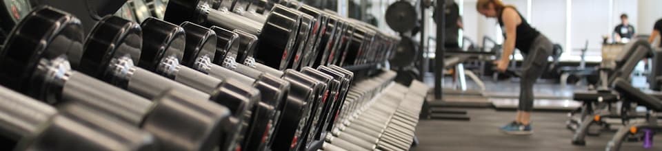 A certified personal trainer guiding a client through a workout session